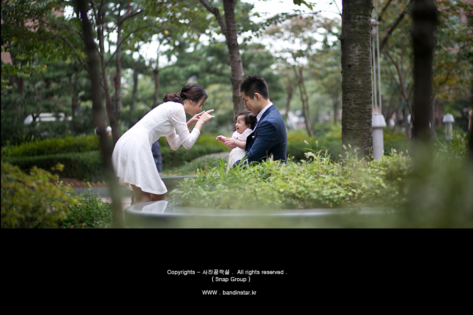 정원 돌길 위 가족 3인 - 나무 사이로